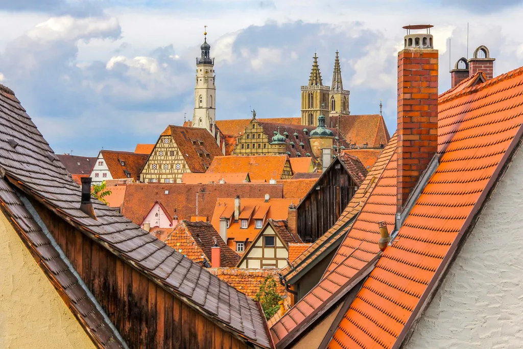 Red-tiled rooftops of Rothenburg ob der Tauber seen from above with church towers behind